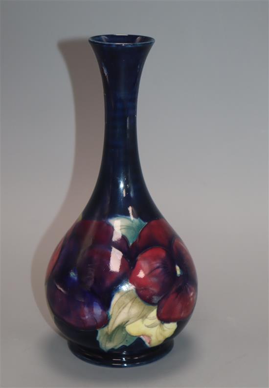 A Moorcroft pansy bottle vase, c.1917, H.21.7cm, professionally restored